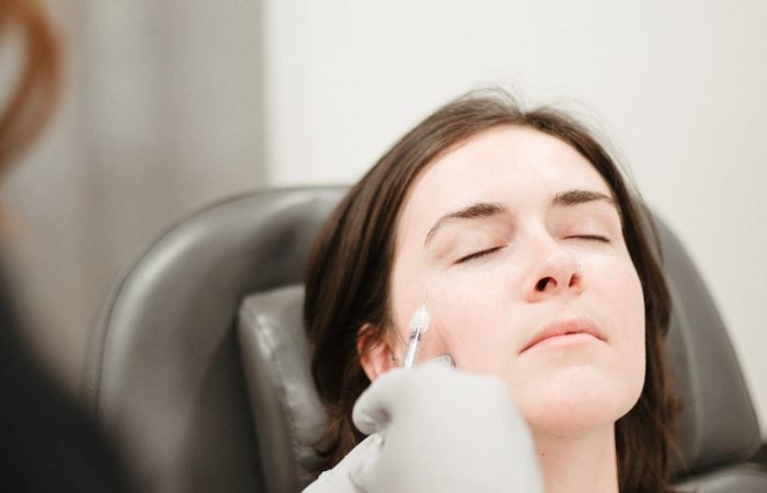 A woman receiving a cheek injection as part of a Botox treatment.
